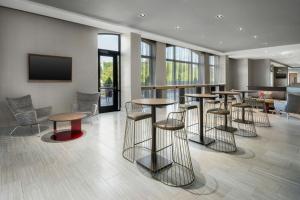 a bar with stools and tables in a lobby at Springhill Suites By Marriott Athens Downtown/University Area in Athens
