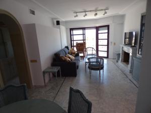 a living room with a couch and a fireplace at Vista Cala del Pino in La Manga del Mar Menor