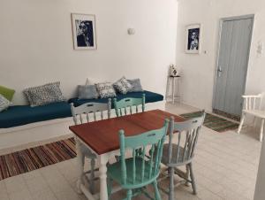 a living room with a table and chairs and a couch at White Cat in Vromolithos