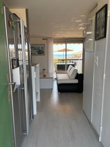 a living room with a couch and a view of the ocean at Magnifique appartement Duplex vue sur la mer in Fleury