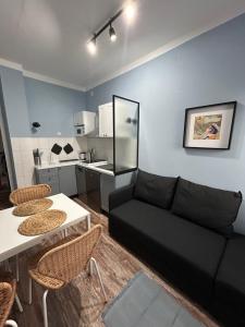 a living room with a couch and a table and chairs at Apartman Chilla 2 in Veliko Gradište