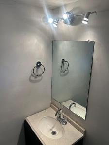 a bathroom with a sink and a mirror at Victoria Deptos & Suites in Ciudad Victoria