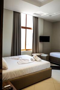 Postel nebo postele na pokoji v ubytování OLI Hotel