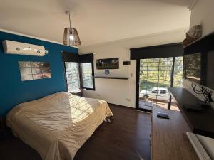 a bedroom with a bed and a blue wall at Quinta en City Bell in City Bell +21 photos