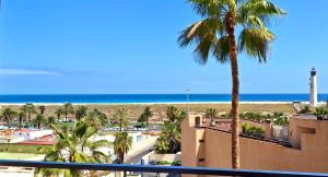 a view of the beach from the balcony of a resort at Sun&Ocean in Morro del Jable