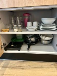 a cupboard filled with plates and bowls and dishes at Casa Canto del Agua in Lorena +1 photo