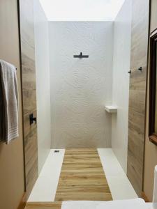 a shower with a glass door in a bathroom at Casa Canto del Agua in Lorena