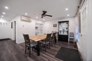 a dining room with a wooden table and chairs at Santa's Village Muskoka Retreat - Waterfront Kayaks Hot Tub in Bracebridge +71 photos