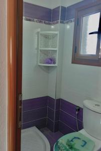 a bathroom with a toilet and a window at Delvina Penthouse in Delvinë +13 photos