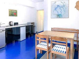 a kitchen with a wooden table and two chairs at Indigo in Bullay