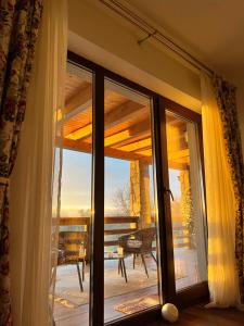 a sliding glass door with a view of a balcony at Maia Dorului in Mereteu