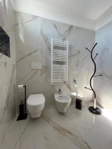 a white bathroom with a toilet and a sink at Rooftop Galatina in Galatina +28 photos