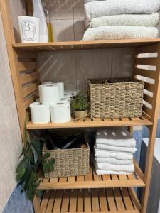 a shelf with towels and baskets and towels at Studio Astir in Tirane