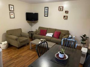 a living room with a couch and a table at Down Home Accommodations in Rocky Harbour