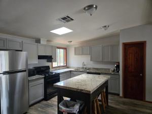 a kitchen with a refrigerator and a table in it at Lumbermen's Village in Pinetop-Lakeside