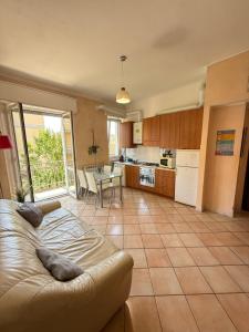 a living room with a couch and a kitchen at House near Milano in Cologno Monzese