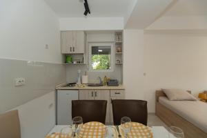 a small kitchen with a table and chairs in a room at Milenkovic Apartments in Gevgelija
