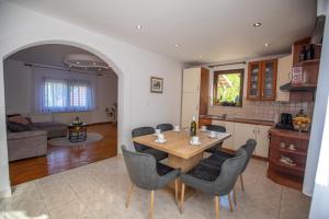 a kitchen and living room with a table and chairs at Lumaris in Ogulin