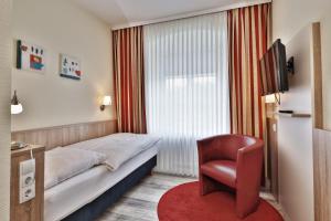 Postel nebo postele na pokoji v ubytování Hotel Trierer Hof
