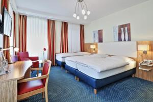 Postel nebo postele na pokoji v ubytování Hotel Trierer Hof + 12 fotografií