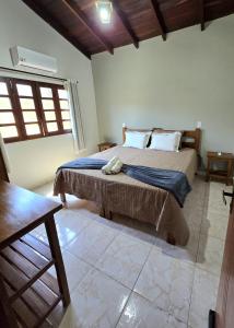 a bedroom with a large bed in a room at Casa Flor de Pitanga- Vila de São Jorge in Sao Jorge +26 photos