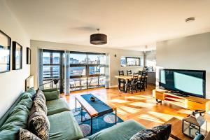 a living room with a couch and a flat screen tv at Glasgow City Flats in Glasgow