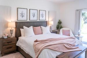 a bedroom with a large bed with a pink blanket on it at Newly built vacation home with large backyard in Diamond Bar
