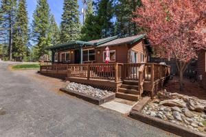 a small cabin with a porch and a driveway at Cozy Lakeside Cabin-Lake Almanor-BoatRamp-Pets-Fun in Westwood