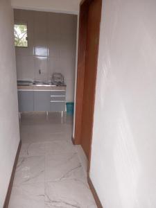 an empty room with a kitchen with a counter at Casa em Lavras Novas - 2 Suítes casal - AP02 in Ouro Preto +5 photos
