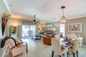 a living room with a table and a dining room at 5 Mi to Fort Myers Beach Home with Heated Pool! in Fort Myers
