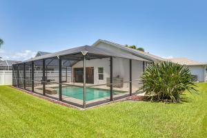 a large glass house with a swimming pool at 5 Mi to Fort Myers Beach Home with Heated Pool! in Fort Myers