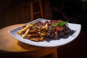 a plate of meat and french fries on a table at Very Muy Epico in San Lucas del Pulque