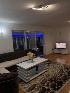 a living room with a couch and a coffee table at Drinska Oaza in Goražde +18 photos
