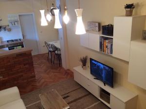 a living room with a flat screen tv on a white cabinet at Apartment Satus in Podstrana