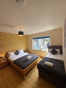a bedroom with two beds and a window at Waterlane Apartments in Galway