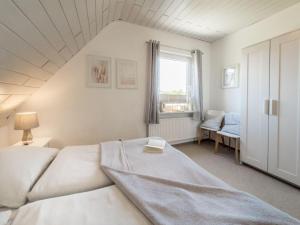 una camera da letto con un letto e una finestra di Strandwind a Oldenburg in Holstein