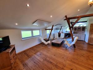 a large living room with a table and chairs at Pugholz Suite in Hasselberg