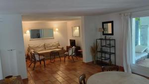 a living room with a couch and a table and chairs at Bastide la Bohême in La Ciotat
