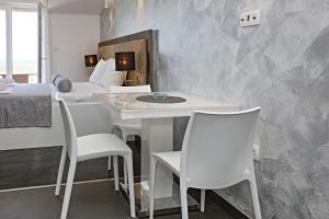 a room with a table and chairs and a bed at Studio Zecevo Rtic 8366a in Rogoznica