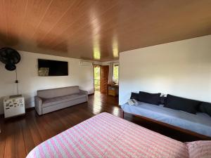 a living room with two beds and a couch at Casa.dovale in Caeté-Açu