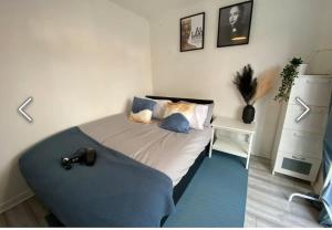 a bedroom with a large bed with a blue rug at Flamingo Short Lets Greenleys in Wolverton