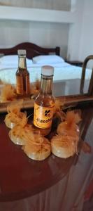 two bottles of honey and some food on a table at Finca MI FUNDO in Acacías