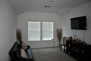 a living room with a couch and a window at Relitorin Sweet Home & Pool in Spring