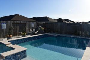a swimming pool in front of a wooden fence at Relitorin Sweet Home & Pool in Spring