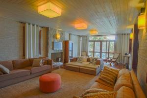 a large living room with couches and a couch at Villa Bermahe in Ilhabela