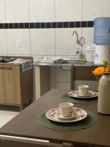 two coffee cups on a table in a kitchen at Apartamento completo e central! CASA DUNAS! in Fortaleza