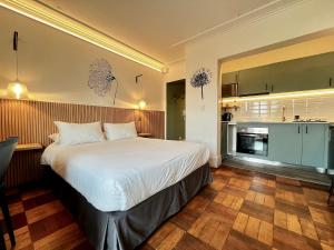 une chambre avec un grand lit et une cuisine dans l'établissement Living Vaisse, à Santiago