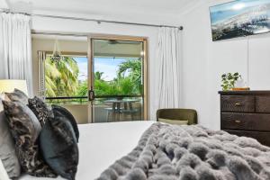 En eller flere senge i et værelse på Pineapple Palms - Resort 9 Pools & Gym