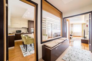 a kitchen and living room with a large window at Skenderija Skyline Luxury- 2BR Apartment with Garage and Balcony in Sarajevo