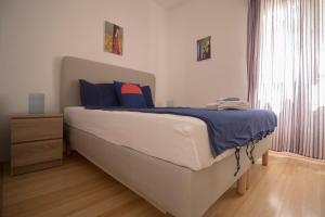 a bedroom with a large bed with blue pillows at Family friendly house with a swimming pool Rukavac, Vis - 24700 in Vis +14 photos